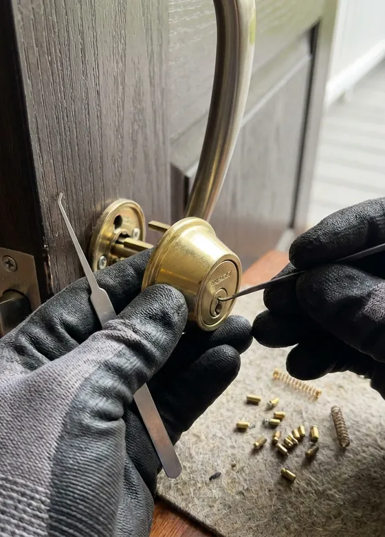 Metro Locksmith technician rekeying a deadbolt on a home's front door